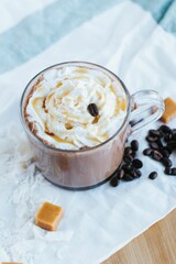 Vertical shot of a caramel hot chocolate on the white background