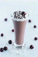 Vertical shot of a fresh chocolate milkshake isolated on empty white background