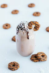 Tuinposter Closeup shot of a delicious cookie shake in a glass jar surrounded by cookies © Jeffrey Bethers/Wirestock Creators