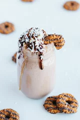 Gordijnen Closeup shot of a delicious cookie shake in a glass jar surrounded by cookies © Jeffrey Bethers/Wirestock Creators