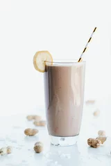 Foto op Canvas Closeup shot of a delicious cookie shake in a tall glass cup surrounded by peanuts © Jeffrey Bethers/Wirestock Creators