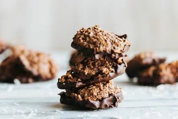  Closeup shot of a stack of no bake cookies dipped in chocolate on the marble kitchen counter © Jeffrey Bethers/Wirestock Creators
