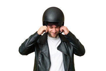 Young caucasian man with a motorcycle helmet isolated on green chroma background frustrated and...