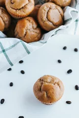 Foto op Plexiglas Vertical shot of blueberry muffins on the white background © Jeffrey Bethers/Wirestock Creators