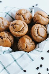 Vertical shot of blueberry muffins on the white background