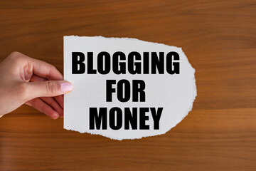 Blogging for money. Woman hand holds a piece of paper with a note, blogging for money. Influencer,...