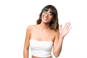 Young caucasian woman over isolated background saluting with hand with happy expression