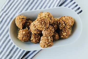 Top view of the cookie bites on a white bowl on a striped fabric