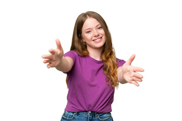 Young pretty woman over isolated background presenting and inviting to come with hand