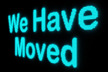 We have moved. Dark LED screen with the text "We have Moved" in blue glowing letters. New business, new address, relocation, announcement and message. 3D illustration