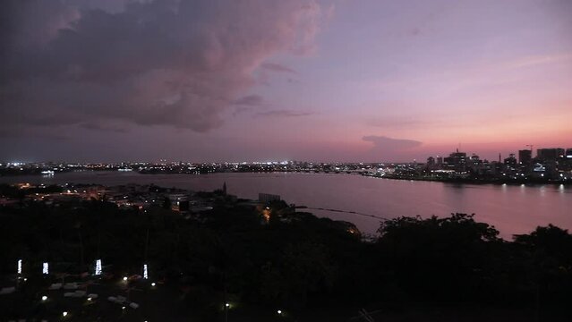 Mesmerizing view of the sunset sky over the night city in Ivory Coast, Abidjan