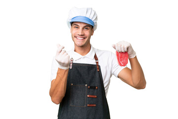 Butcher caucasian man wearing an apron and serving fresh cut meat over isolated background making money gesture