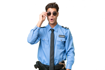 Young police man over isolated background with glasses and surprised