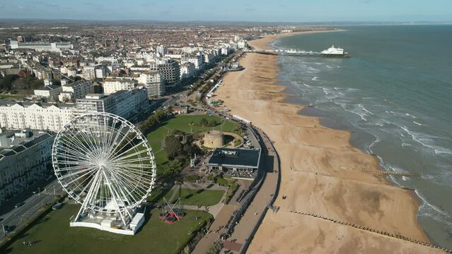 Aerial view of the sea side town of Eastbourne in UK. Wheel and Pier in the seaside town resort in the Atlantic Ocean, sunny day - landscape panorama of United Kingdom