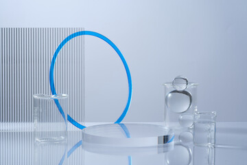 Pedestal for cosmetic product display presentation with transparent podium, glass ball, beakers and...