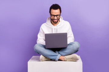 Full length photo of stylish wear latin man coder freelancer found new coworking zone sit platform...