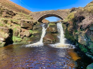 Three shires waterfalls stone arch bridge in the peak district uk 