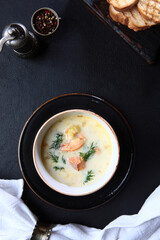 Shrimp and red fish in a traditional French soup. Soup with seafood and cream.A white napkin.Flat lay. Top view.