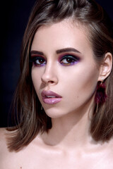 Fototapeta premium Beautiful woman with bright multicolor celebration make up Chic evening make-up. Fashion retouched portrait.