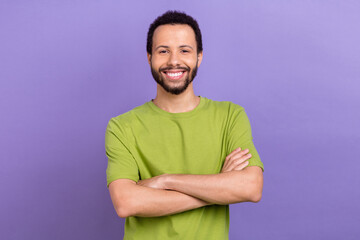 Photo of positive friendly guy crossed arms beaming smile isolated on violet color background