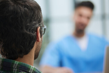 Fototapeta premium Doctor with patient in medical office at the reception