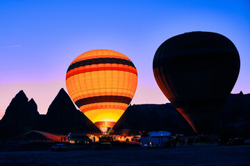Fototapeta premium Colorful hot air balloons. Sunrise at Cappadocia. Bright colorful ballons ascending during sunrise in valley. Goreme, Nevsehir, Cappadocia