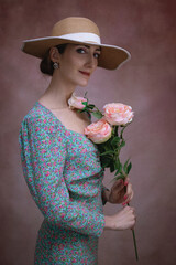Romantic woman in hat with bouquet of flowers.Art processing.