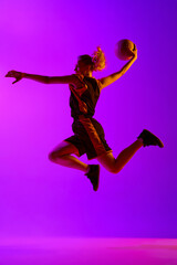 Fototapeta na wymiar Full-length dynamical image of young female basketball player, girl training with ball against white studio background. Concept of professional sport, hobby, healthy lifestyle, action and motion