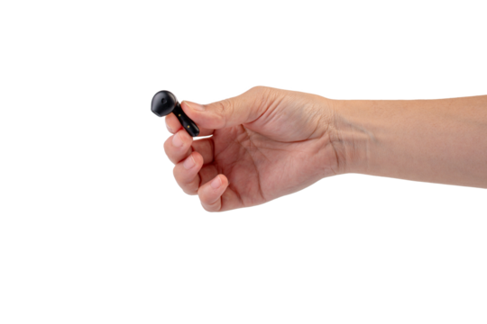 Wireless black bluetooth earphones in hand isolated close-up on a transparent background