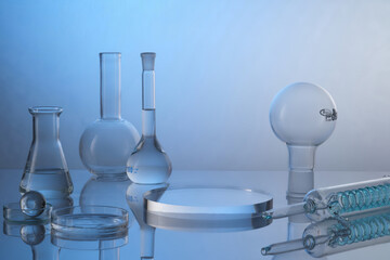 Laboratory glass equipment with transparent water ingredients on color background. Research and development cosmetics concept. Stage showcase cosmetics on glass pedestal modern in laboratory equipment