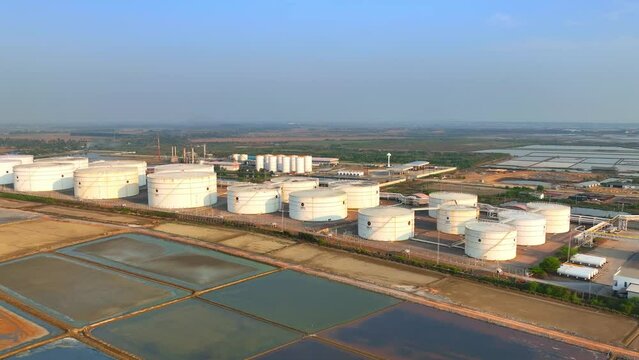 An oil depot is a large industrial facility used for the storage and distribution of petroleum products such as gasoline, diesel, and jet fuel. fuel and energy concept. aerial view from drone. HDR
