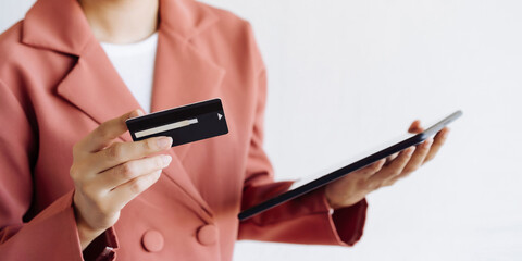 Woman's hand holding a credit card online shopping addiction