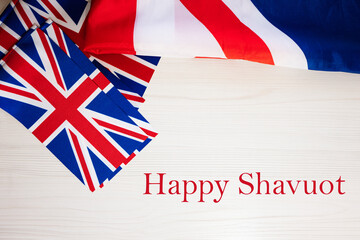 Happy Shavuot. British holidays concept. Holiday in United Kingdom. Great Britain flag background.