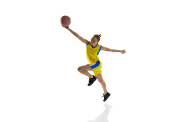 Fototapeta na wymiar Young sportive girl in uniform, training with ball, playing basketball against white studio background. Isometric view. Concept of professional sport, hobby, healthy lifestyle, action and motion