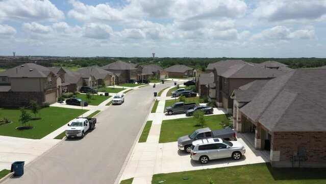 Aerial of residential buildings and parked cars in Texas, United States.