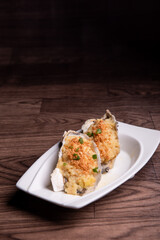fresh western seafood steamed 2 big oyster shell with garlic ginger sauce in white plate on wood table luxury halal food fine dining restaurant menu