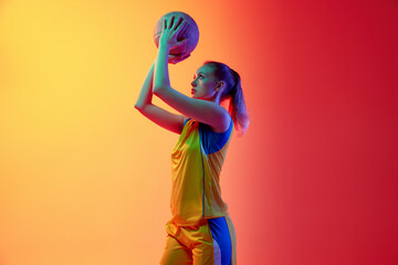 Winner. Concentrated, motivated female basketball player, young girl during game, posing with ball against white studio background. Concept of professional sport, hobby, healthy lifestyle, motion