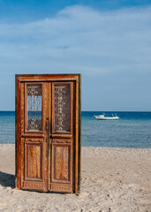 Art object in the form of a door on the shore of the Red Sea, a photo zone for tourists