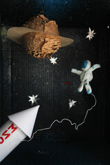 School kindergarten handmade crafts, paper spaceship, shuttle, planet, astronaut on dark background. diy, recycle, space day, cosmonautics day