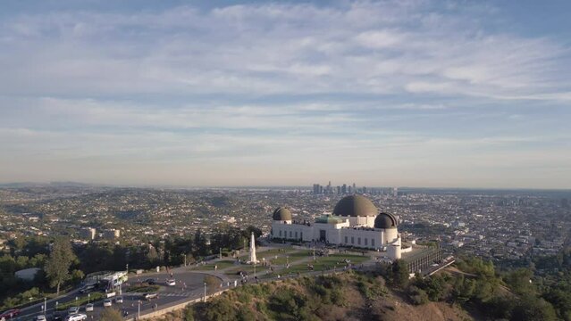 Drone view of the Griffith Observatory surrounded by greenery under the sunlight in California