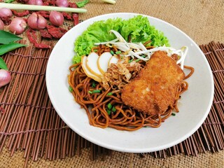 Deep Fried Chicken Dry Noodle served dish isolated on table top view of thai food