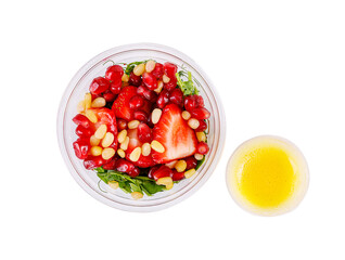 Salad with microgreens, strawberries, pine nuts and pomegranate seeds. Isolated, on a white background. Top view