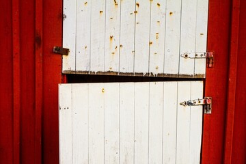 Closeup shot of rusty painted white red barn doors