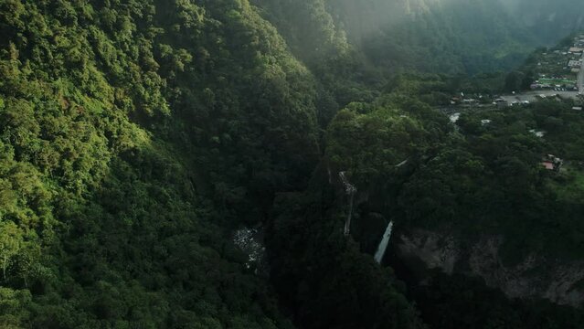 Aerial view of a raging waterfall surrounded by trees and rocks