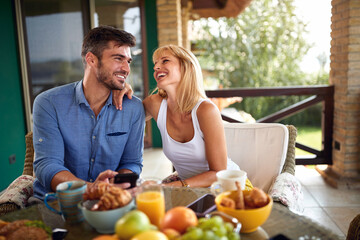 Man and woman having fun during breakfast