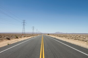 Empty highway road with dry plant fields on each side on a sunny day