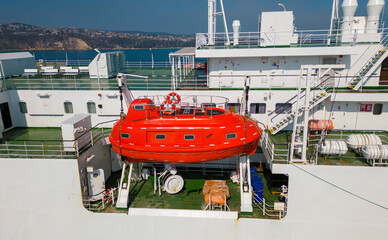 lifeboat on a ferry, which is a crucial safety measure for emergency situations.