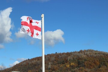 Georgian flag against a clear blue sky