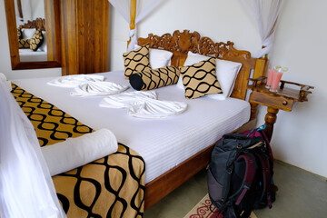 travel backpack leaning against wooden bed in apartment room, hotel near four-poster bed with...