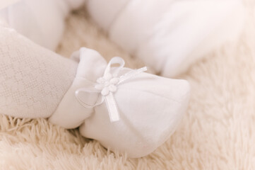 A small child's foot in a white slipper